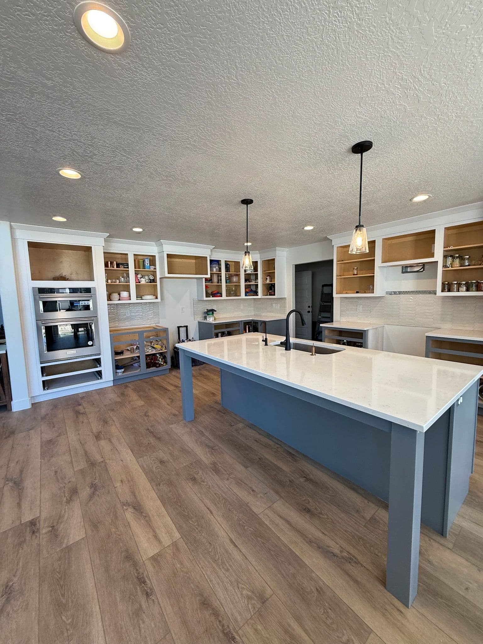 Kitchen Remodel Featuring Elegant White Cabinets and Chic Island image